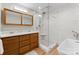 Bright bathroom featuring a glass shower, soaking tub, double vanity, modern fixtures, and wood look flooring at 315 Arlington Ave # 506 & 507, Charlotte, NC 28203