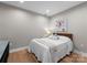 Cozy bedroom featuring hardwood floors, a comfortable queen-size bed, and a serene atmosphere at 315 Arlington Ave # 506 & 507, Charlotte, NC 28203