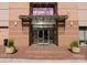 Inviting brick building entrance with modern glass doors and manicured landscaping, enhancing the property's curb appeal at 315 Arlington Ave # 506 & 507, Charlotte, NC 28203