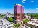 View of a high-rise building featuring a sleek, modern design, framed by lush trees and a clear sky at 315 Arlington Ave # 506 & 507, Charlotte, NC 28203