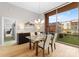Bright dining room with modern table setting, wood floors, and large windows looking onto green space at 315 Arlington Ave # 506 & 507, Charlotte, NC 28203