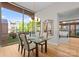 Bright dining room features hardwood floors, modern lighting, and a clear view of the exterior greenery at 315 Arlington Ave # 506 & 507, Charlotte, NC 28203