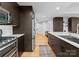 Modern kitchen with stainless steel appliances, marble countertops, and wood floors with access to other rooms at 315 Arlington Ave # 506 & 507, Charlotte, NC 28203