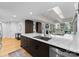 Bright kitchen features a large marble countertop island with stainless steel appliances and views to outdoor seating at 315 Arlington Ave # 506 & 507, Charlotte, NC 28203