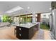 Open-concept kitchen featuring a marble island, stainless steel appliances, and a view into the spacious living room at 315 Arlington Ave # 506 & 507, Charlotte, NC 28203