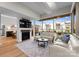 Modern living room with fireplace, wood floors, and bright windows looking onto the patio and green space at 315 Arlington Ave # 506 & 507, Charlotte, NC 28203