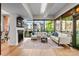 Modern living room with a fireplace, oversized windows, and wood floors at 315 Arlington Ave # 506 & 507, Charlotte, NC 28203