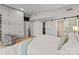 Spacious main bedroom featuring built-in storage, sliding barn door, and comfortable seating area at 315 Arlington Ave # 506 & 507, Charlotte, NC 28203