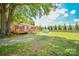 Picture of an expansive backyard with large tree, shed, and a wooden deck at 3203 Valleydale Rd, Monroe, NC 28110