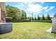 Large, fenced backyard with green grass, offering plenty of space for outdoor activities and relaxation at 3203 Valleydale Rd, Monroe, NC 28110
