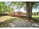 Expansive backyard with mature tree, deck, and gravel area at 3203 Valleydale Rd, Monroe, NC 28110