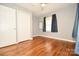 Bright bedroom with hardwood floors, a ceiling fan, a window, and closet space at 3203 Valleydale Rd, Monroe, NC 28110