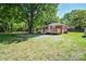 Charming brick home featuring a well-maintained lawn and a cozy wooden deck perfect for outdoor relaxation at 3203 Valleydale Rd, Monroe, NC 28110