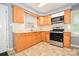 Practical kitchen featuring oak cabinets, laminate countertops, and modern appliances, designed for efficient meal preparation at 3203 Valleydale Rd, Monroe, NC 28110