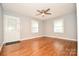 Inviting living room featuring gleaming hardwood floors, neutral walls, and natural light from two windows at 3203 Valleydale Rd, Monroe, NC 28110