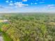 Aerial view showcasing the property's positioning within a mixed landscape of wooded areas and community features at 322 S Main St, Shelby, NC 28152