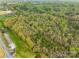 An aerial shot highlights the property's tree coverage and proximity to green lawns, showcasing a serene and inviting setting at 322 S Main St, Shelby, NC 28152