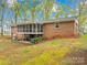 Back exterior of brick home features screened porch, garage and spacious backyard at 322 S Main St, Shelby, NC 28152
