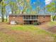 Back exterior of brick home features screened porch, garage and spacious backyard at 322 S Main St, Shelby, NC 28152