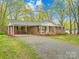 Charming single-story brick home with well-maintained lawn, covered parking and front porch at 322 S Main St, Shelby, NC 28152