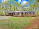 Charming single-story brick home with well-maintained lawn, covered parking and front porch at 322 S Main St, Shelby, NC 28152
