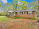 Charming single-story brick home with well-maintained lawn and covered front porch at 322 S Main St, Shelby, NC 28152