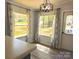 Eat-in kitchen area with large windows, modern lighting, wooden floors and stylish patterned curtains at 3325 Stony Brook Cir, Newton, NC 28658