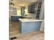 Modern eat-in kitchen featuring gray cabinets with white countertops, stainless steel appliances, and wooden floors at 3325 Stony Brook Cir, Newton, NC 28658