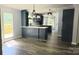 Bright eat-in kitchen with modern lighting, gray cabinets, white countertops and stainless steel sink at 3325 Stony Brook Cir, Newton, NC 28658