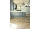 Modern kitchen with gray cabinets, white countertops, stainless steel sink and wooden-style floors at 3325 Stony Brook Cir, Newton, NC 28658