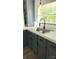 Close up of the sink, gray cabinets and white countertops in a modern kitchen at 3325 Stony Brook Cir, Newton, NC 28658