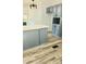 Modern kitchen with gray cabinets, white countertops, stainless steel sink and wooden-style floors at 3325 Stony Brook Cir, Newton, NC 28658