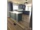 Modern kitchen with gray cabinets, white countertops, stainless steel sink and wooden-style floors at 3325 Stony Brook Cir, Newton, NC 28658
