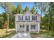 Charming two-story home featuring a covered porch and a well-maintained front yard surrounded by mature trees at 3354 W Sugar Creek Rd, Charlotte, NC 28269
