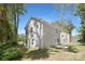 Two-story home featuring light siding, a patio, and a well-maintained lawn with mature trees at 3354 W Sugar Creek Rd, Charlotte, NC 28269