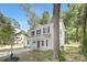 Two-story home with white siding, a front porch, and lush landscaping at 3354 W Sugar Creek Rd, Charlotte, NC 28269