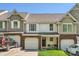 Charming townhome featuring a brick facade, attached garage, and a small front lawn at 3420 Caldwell Ridge Pkwy, Charlotte, NC 28213