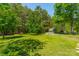 A spacious grassy backyard featuring mature trees and a shed at 3901 Parkers Fry None, Fort Mill, SC 29715
