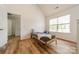 Bright bedroom showcasing wood floors, a window and an entry door at 3901 Parkers Fry None, Fort Mill, SC 29715