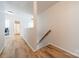 Bright hallway with wood floors leading to other rooms and a staircase at 3901 Parkers Fry None, Fort Mill, SC 29715