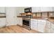 Updated kitchen with white cabinets, wood countertops, stainless steel appliances, and wood look floors at 3901 Parkers Fry None, Fort Mill, SC 29715
