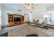 Cozy living room with neutral carpet, a ceiling fan and an entertainment center for media and storage at 3901 Parkers Fry None, Fort Mill, SC 29715