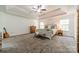 Bright main bedroom with tray ceiling, neutral decor, and ample natural light creates a serene and spacious retreat at 3901 Parkers Fry None, Fort Mill, SC 29715