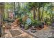 Landscaped backyard featuring a paved patio, lush greenery, and colorful flowers at 394 Runnymede Dr, Rock Hill, SC 29732