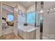 Bright bathroom showcasing a soaking tub, tiled floors, and a separate shower at 394 Runnymede Dr, Rock Hill, SC 29732