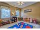 Bright bedroom featuring two windows, decorative curtains, and playful decor for  at 394 Runnymede Dr, Rock Hill, SC 29732