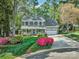 Attractive two-story home boasts a well-manicured lawn and inviting porch with seasonal flower baskets at 394 Runnymede Dr, Rock Hill, SC 29732