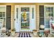 Close-up of a stylish white front door with decorative glass panels, potted plants, and a welcoming atmosphere at 394 Runnymede Dr, Rock Hill, SC 29732