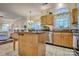 Bright kitchen featuring wood cabinets, stainless steel appliances and a large island with a butcher block counter at 394 Runnymede Dr, Rock Hill, SC 29732
