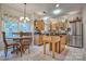 Bright kitchen with wood cabinets, stainless steel appliances, a center island, and a cozy dining area at 394 Runnymede Dr, Rock Hill, SC 29732